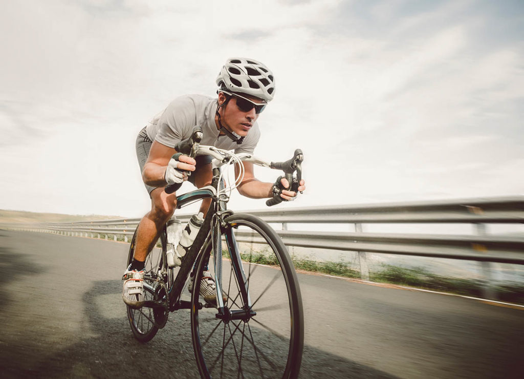 Cyclist pedalling on a racing bike outdoors