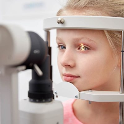 girl checking vision with tonometer at eye clinic