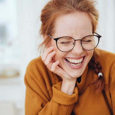 woman laughing with glasses